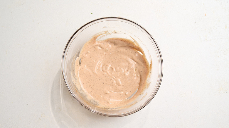 whisking burger sauce ingredients together
