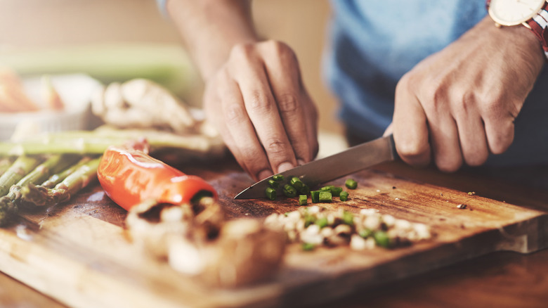 home cook chopping ingredients for recipe