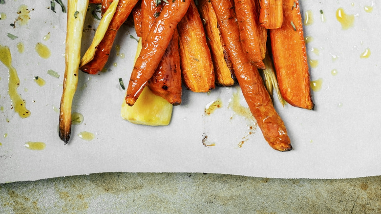 Roasted carrots and parsnips on parchment paper