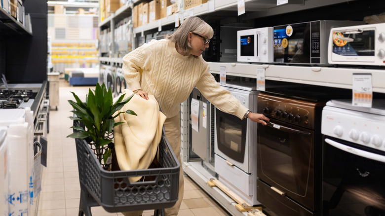 Person shopping for an oven at a store.