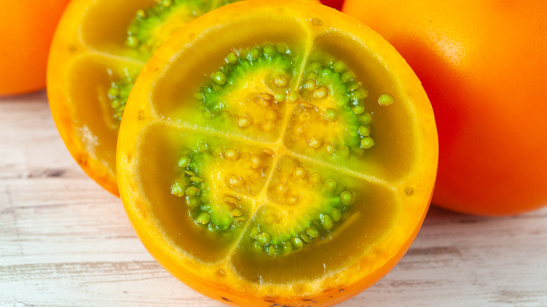 A sliced lulo fruit with four segments