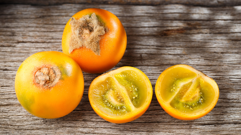 Whole and sliced lulo fruit