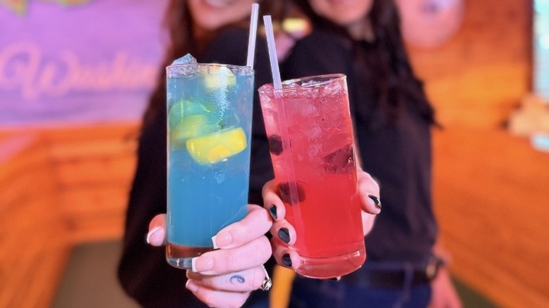 two people holding mocktails at a Texas Roadhouse