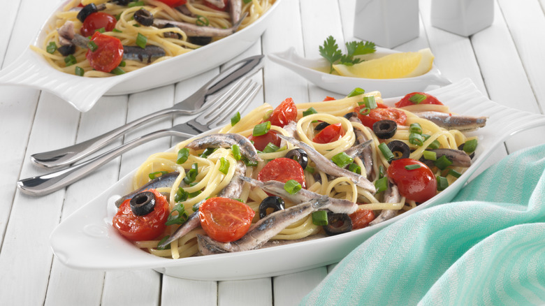 Pasta with sardines is plated on a platter.