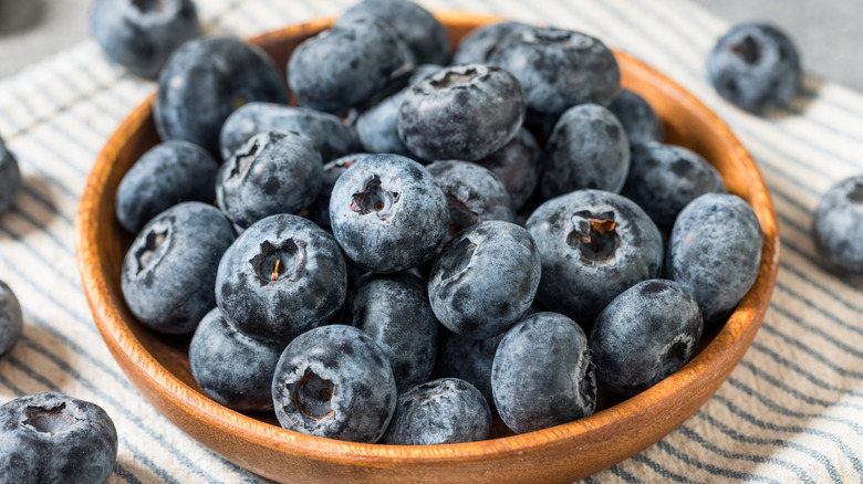 A close-up of a bowl of plump, fresh blueberries