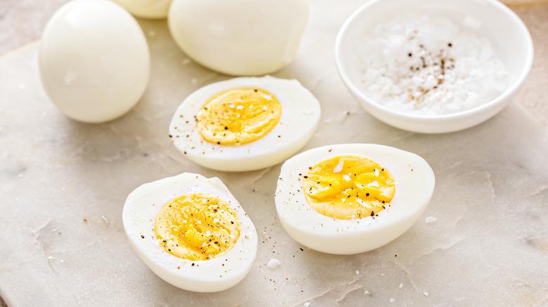 Hard-boiled eggs cut in half with salt and pepper