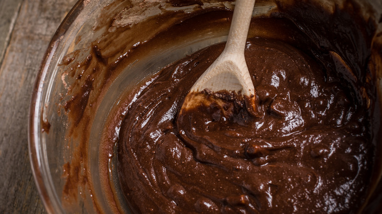 wooden spoon mixing brownie batter