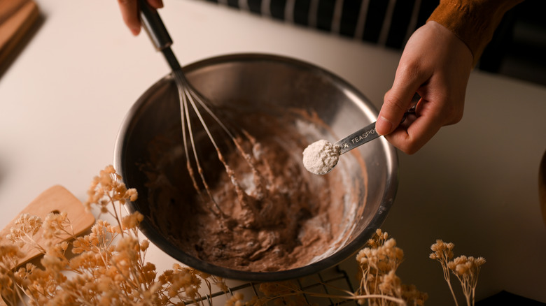 Adding a teaspoon of powdered milk to chocolate cookie dough.
