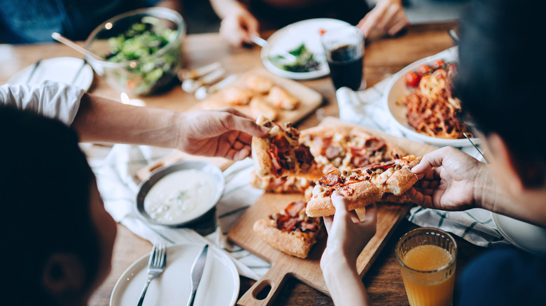 friends eating pizza together