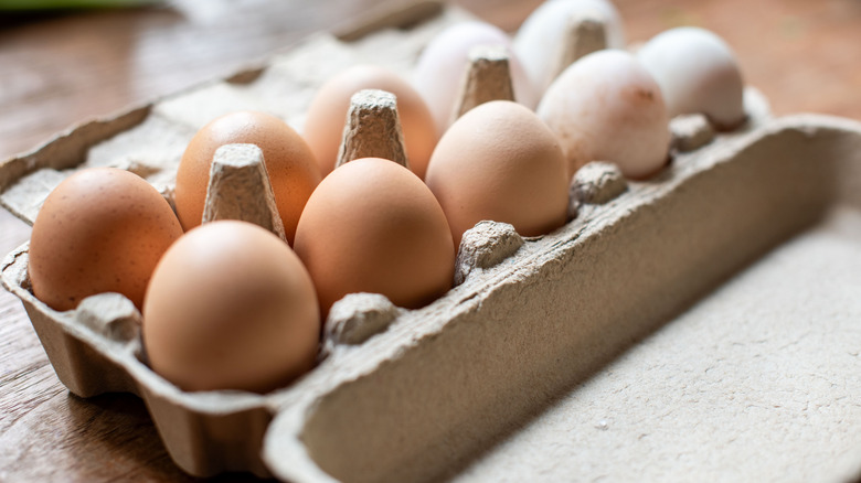 Carton of brown and white eggs.