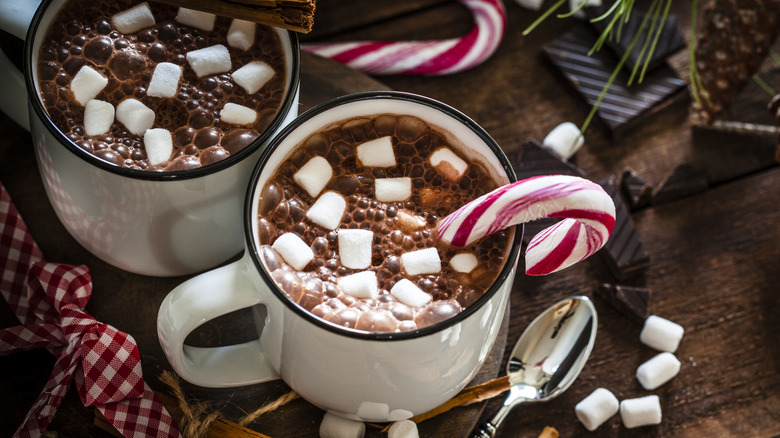 Hot chocolate garnished with candy canes and marshmallows