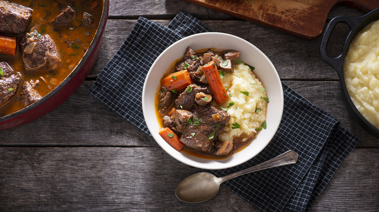 Beef Bourguignon served alongside mashed potatoes.