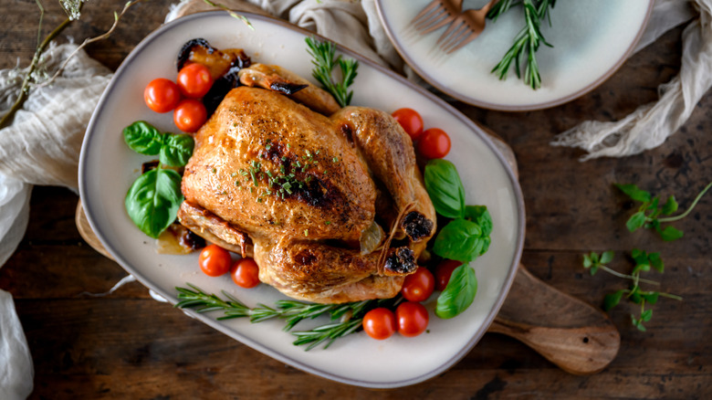 Roasted chicken with herbs and tomatoes.