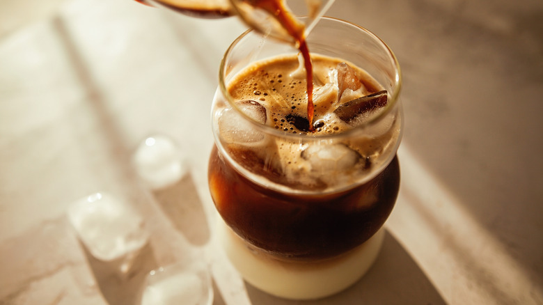 A glass with iced coffee.