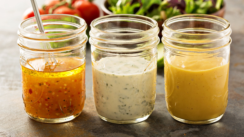 three salad dressings and salad