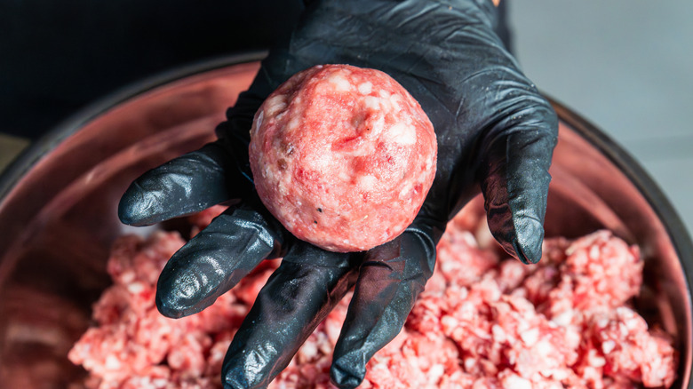 Burger patties formed in hand.