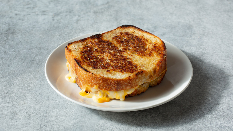 A melty grilled cheese sandwich on a plate