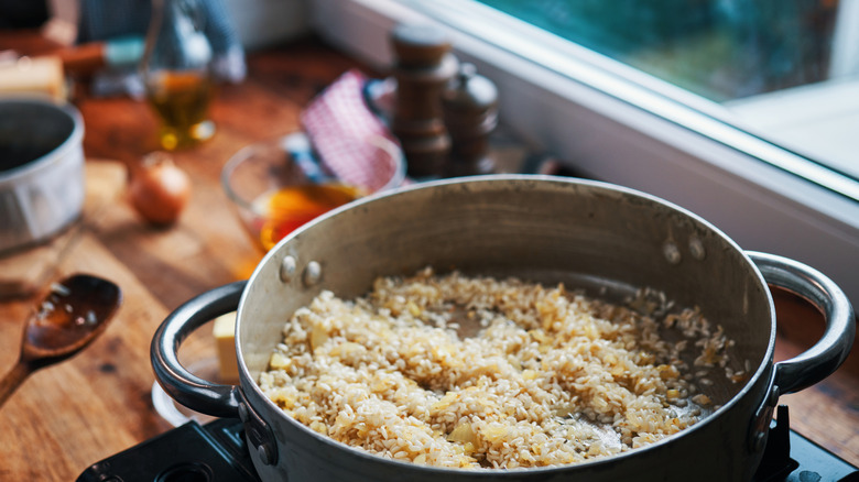 Toasting rice with onions in pan