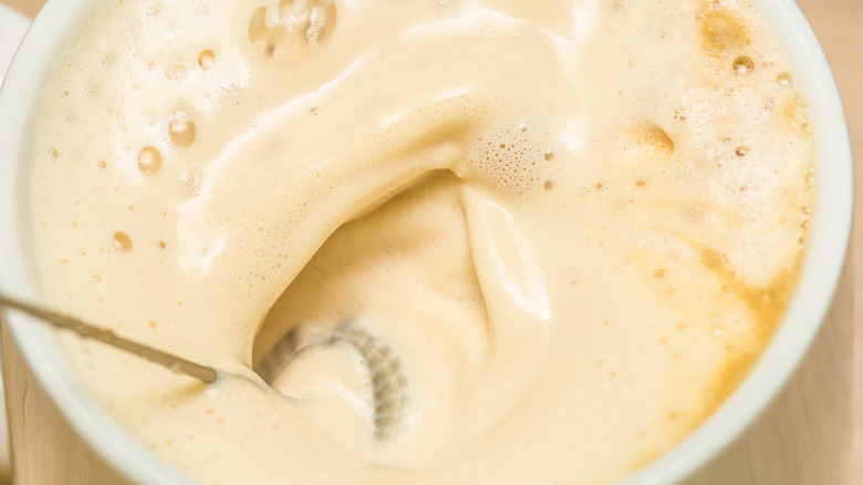 Close-up of milk and coffee being frothed