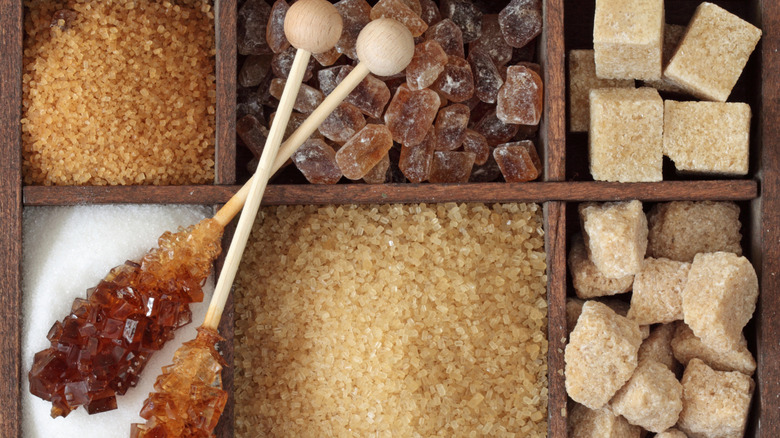 A variety of different sugars in a divided wooden box