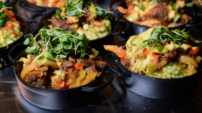 Lamb tajine in black cast iron pots