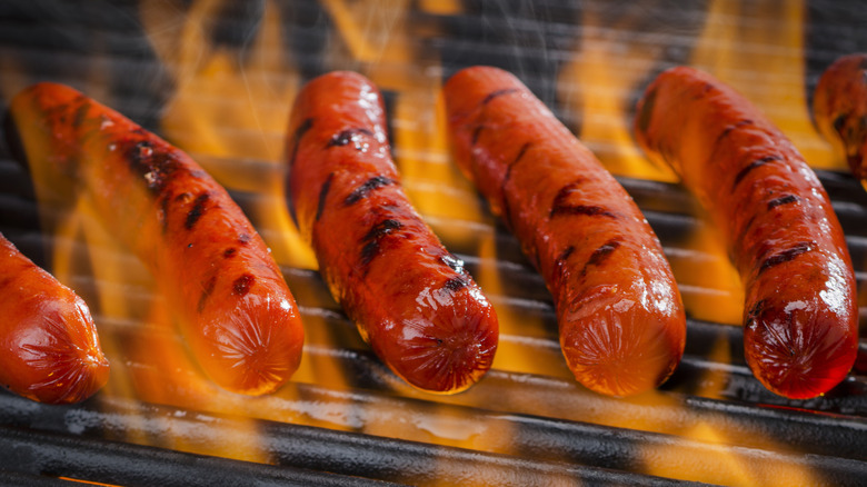 Hot dogs on a flaming hot grill