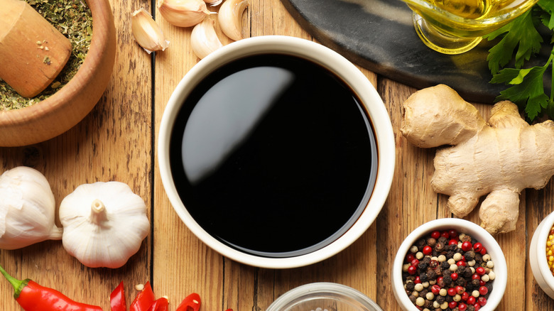 A soy sauce marinade surrounded by different ingredients.