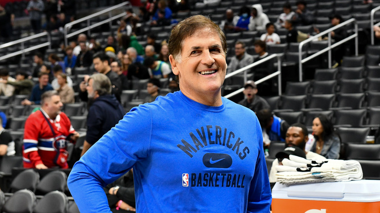 Mark Cuban in basketball stadium wearing blue Mavericks shirt