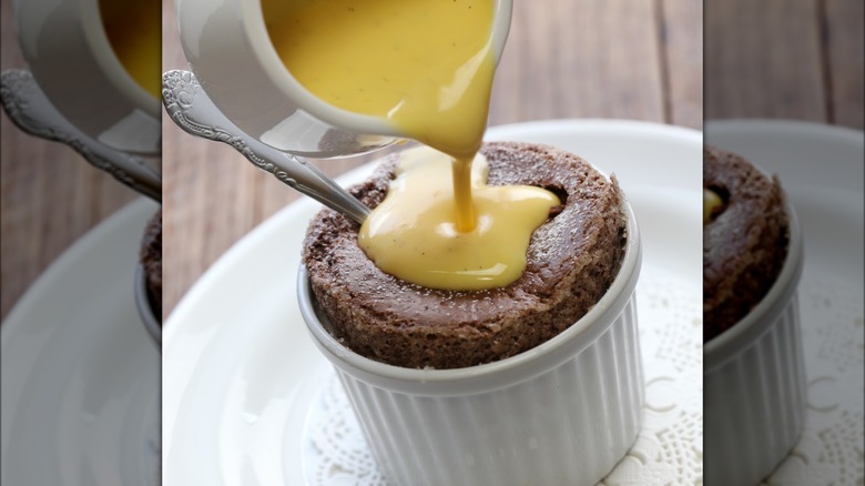 Pouring creme anglaise onto chocolate souffle