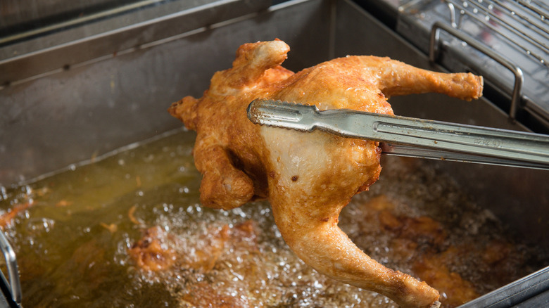 Whole chicken cooked in a deep fryer