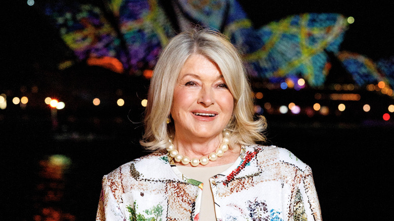 Martha Stewart smiles and poses in front of the famous Sydney Opera House