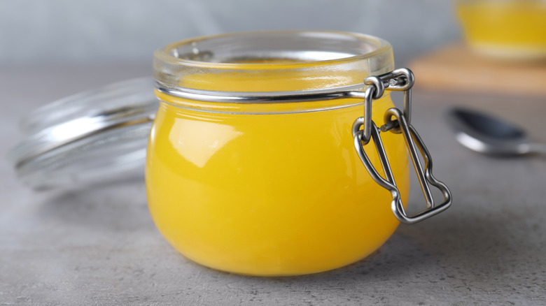 Jar of clarified butter on table