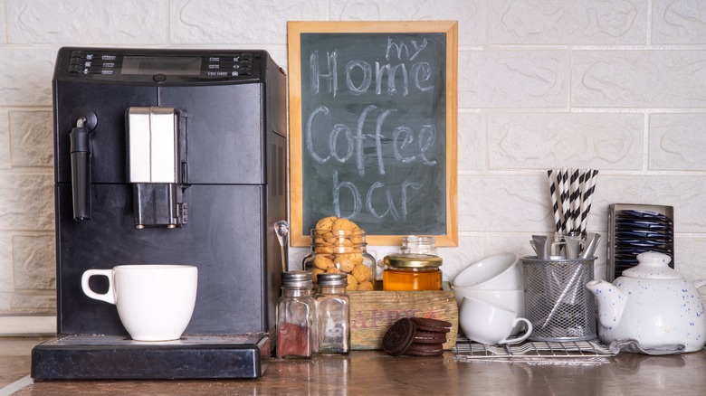 Coffee station with mugs, machine, and more in home kitchen