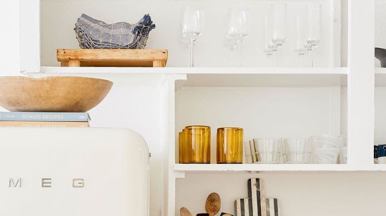 Open kitchen shelving with various types of glassware
