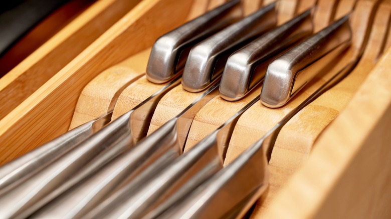 Knife set in an open kitchen drawer