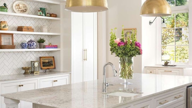 Designer kitchen with marble counters and fresh flowers