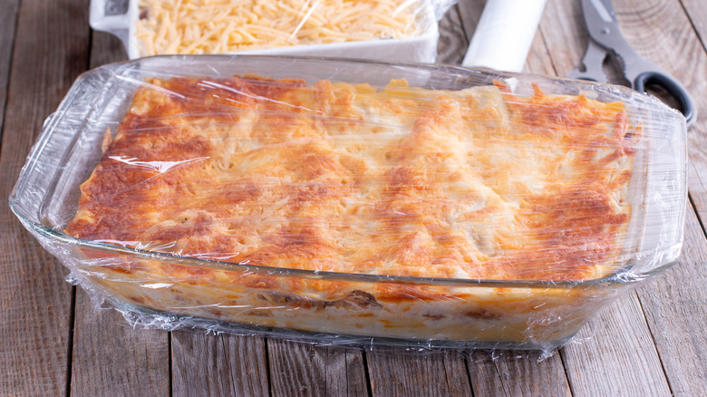 Lasagna covered in cling wrap