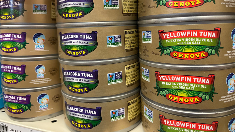 Genova brand canned tuna stacked on a store shelf