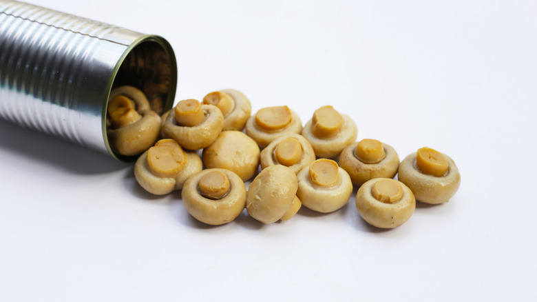 Champignon mushrooms spilling out of a can