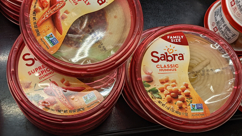 Stacked containers of Sabra hummus
