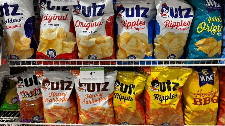 Assorted bags of Utz potato chips on a store shelf