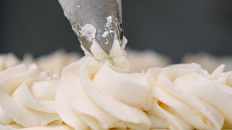 Close-up of piping white frosting