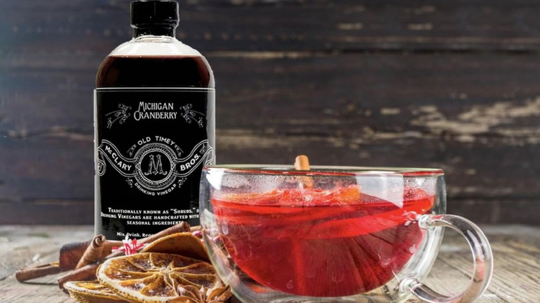 Bottle and glass cup of McClary Bros cranberry drinking vinegar