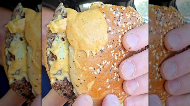 close up of Big Arch burger with sauce exploding out of the side.