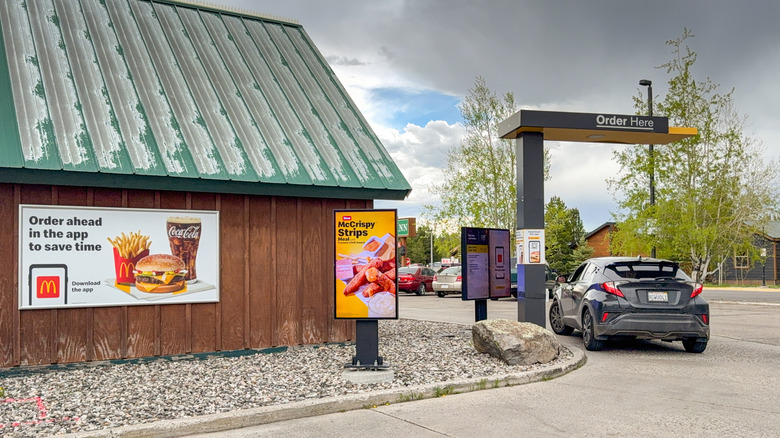 A car orders food at a McDonald's drive-thru