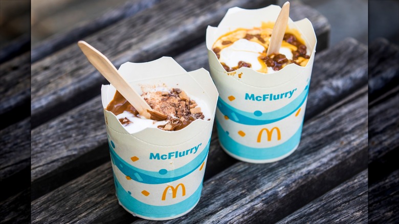Two McFlurries sit on a wooden surface