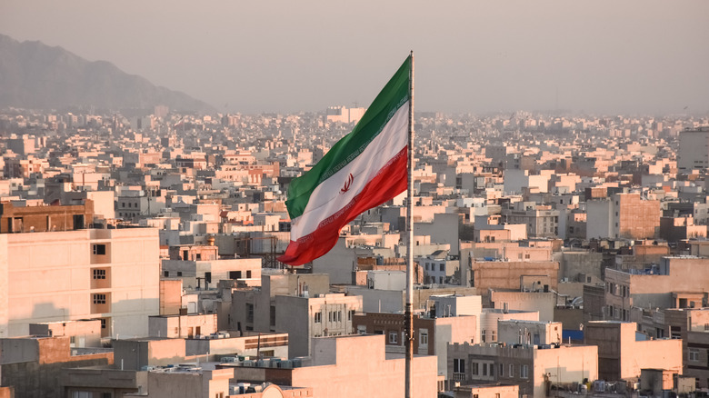Islamic Republic's flag above city of Tehran