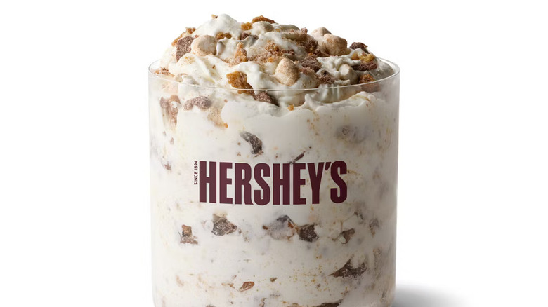 A Hershey's S'mores McFlurry sits in a clear glass against a white backgorund