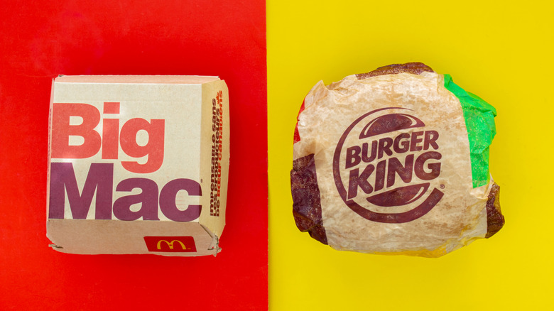 A Big Mac box from McDonald's sits next to a wrapped Whopper from Burger King