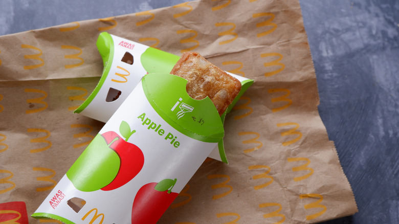 McDonald's apple pies resting on a McDonald's bag.